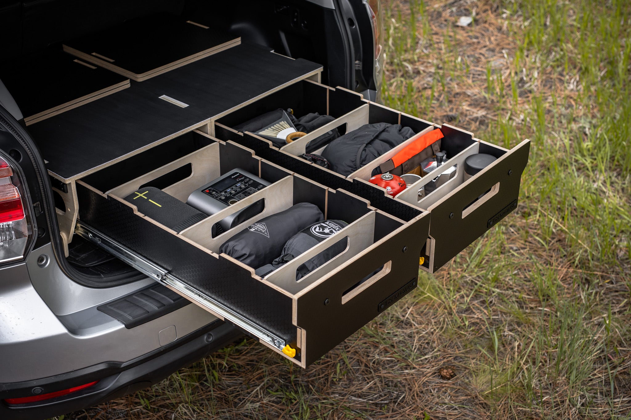 Trekhaus SUV Camper System with tools and equipment in a natural setting