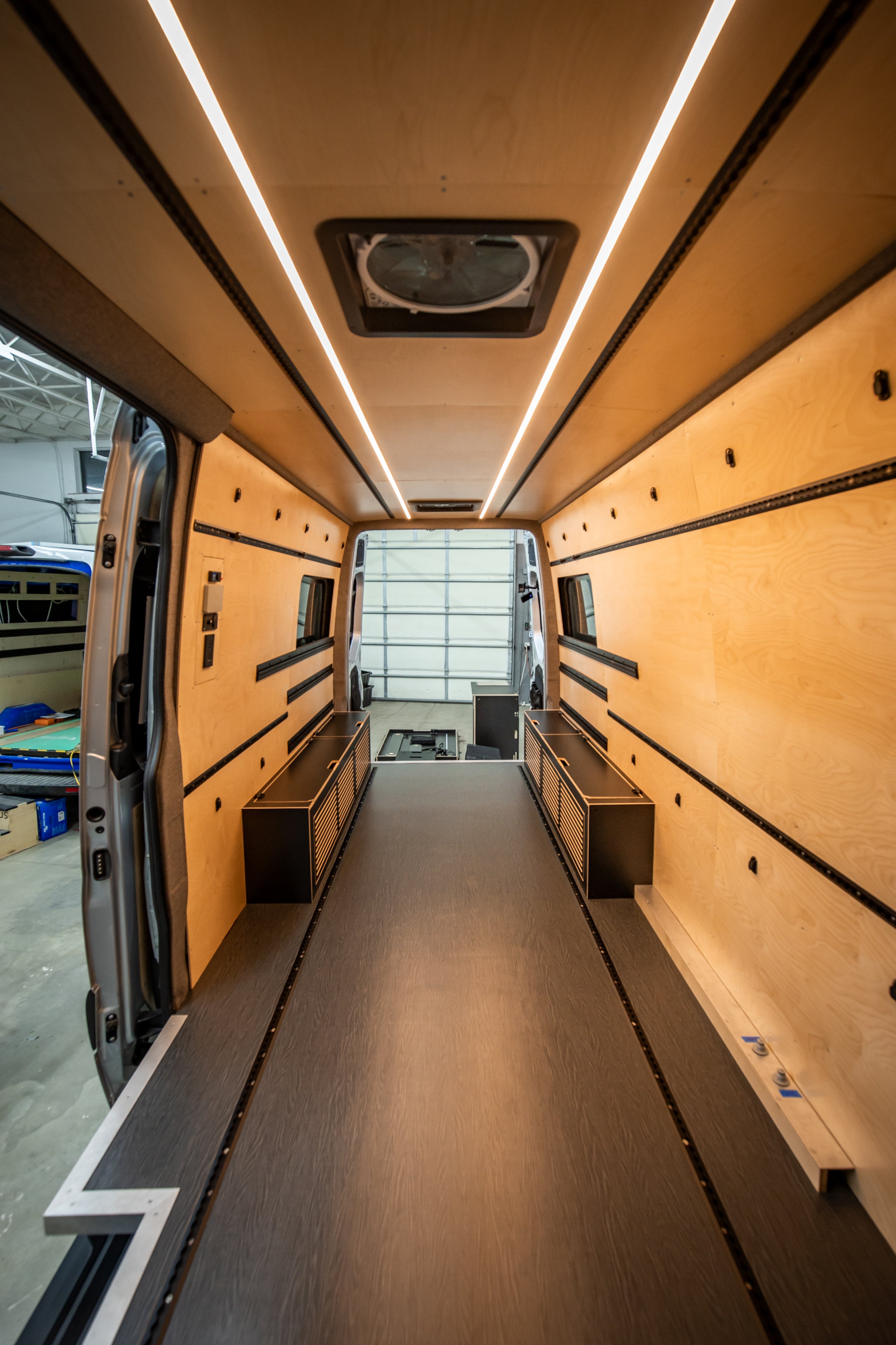 Interior of a van with wooden paneling and LED strip lights